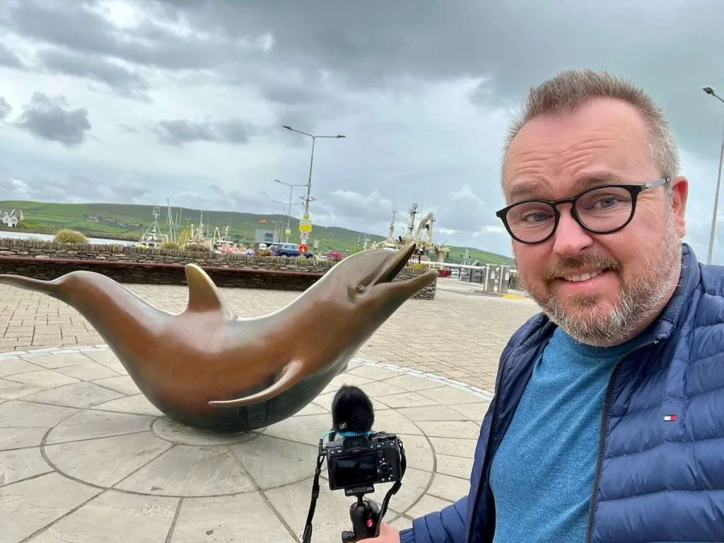Patrick Hughes at the Fungie statue in Dingle