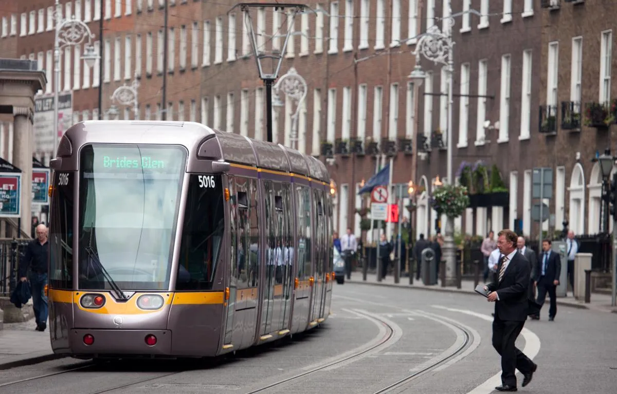 The Luas in Dublin passing along a street.